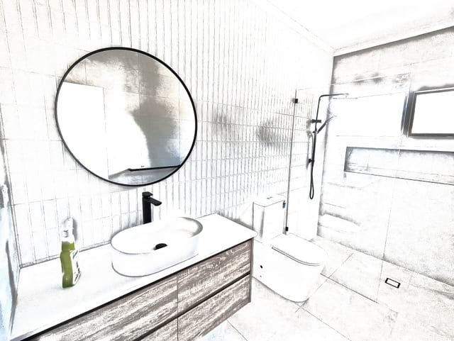 Renovated modern bathroom with stone-top vanity, frameless shower screen and large-format floor tiles